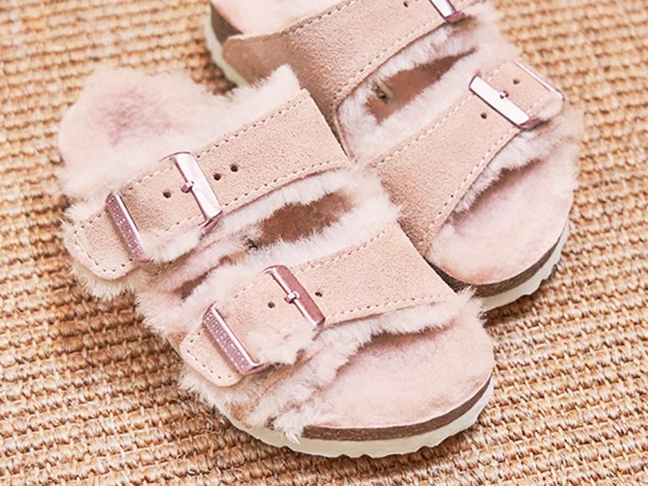 pair of light pink fuzzy birkenstock sandals