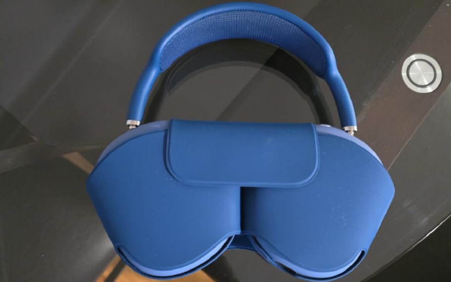 Blue apple airpod max displayed on a table