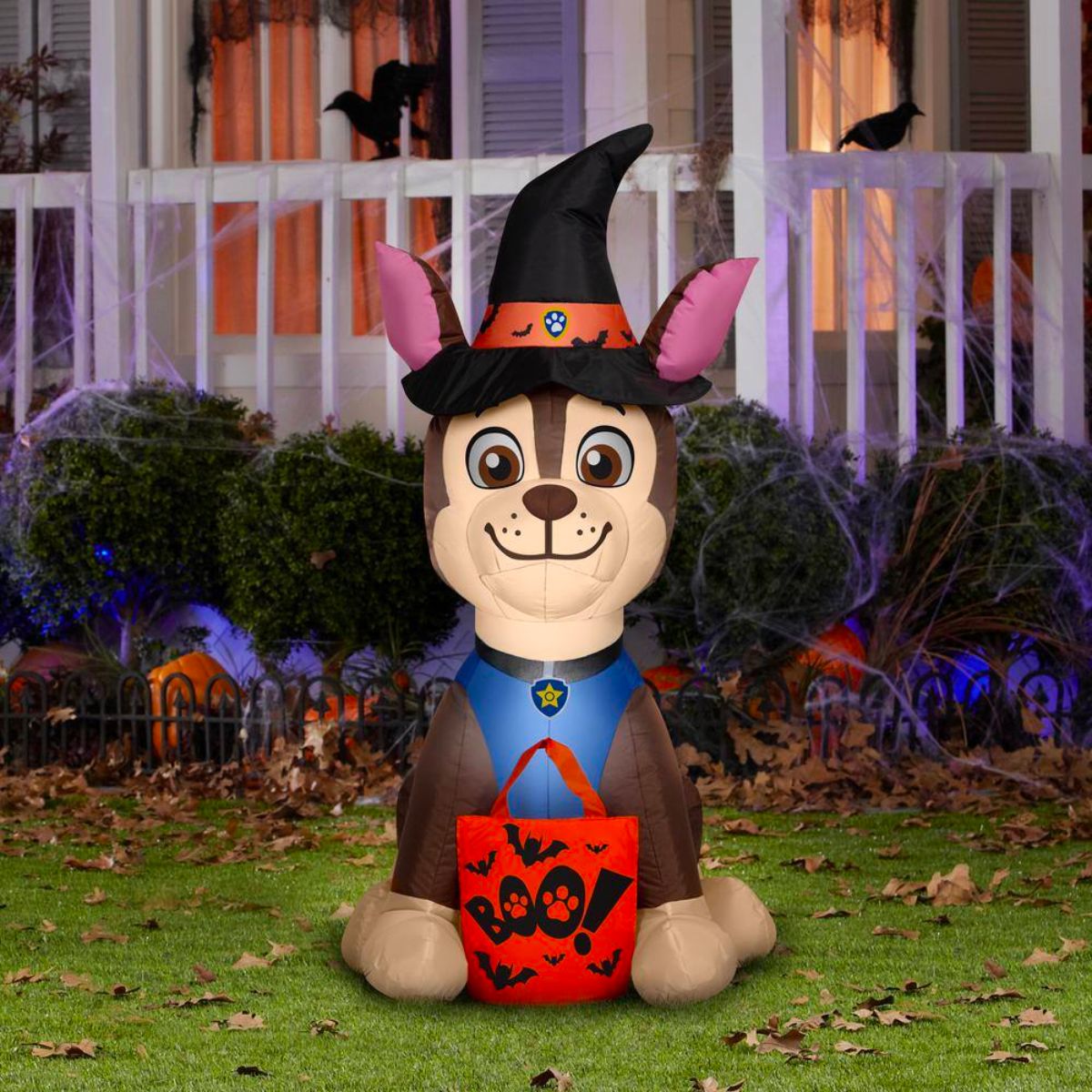 Chase in Witch Costume INFLATABLE HALLOWEEN DECORATION on a lawn in front of a house