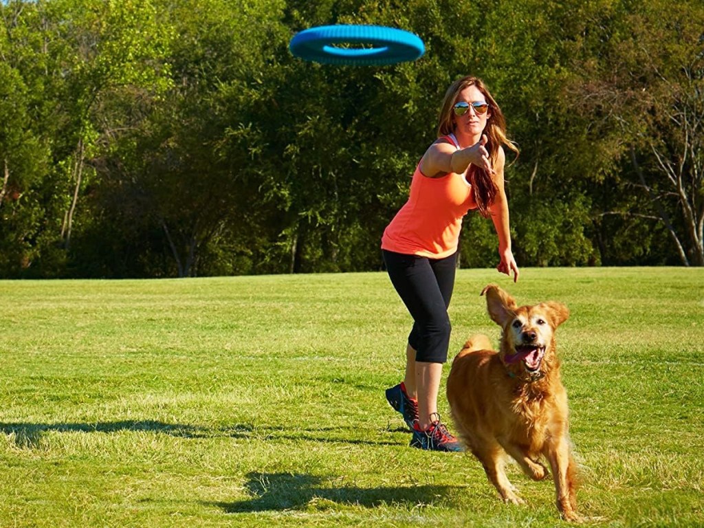woman throwing blue Chuckit! Rugged Flyer Dog Toy for dog
