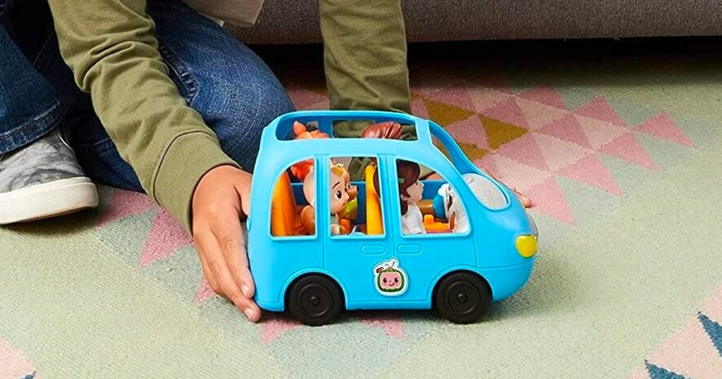 kid playing with CoComelon Deluxe Family Fun Car