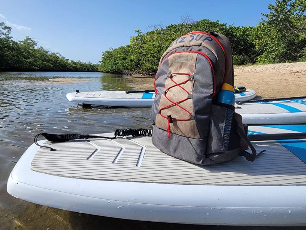 A back pack cooler on a paddleboard