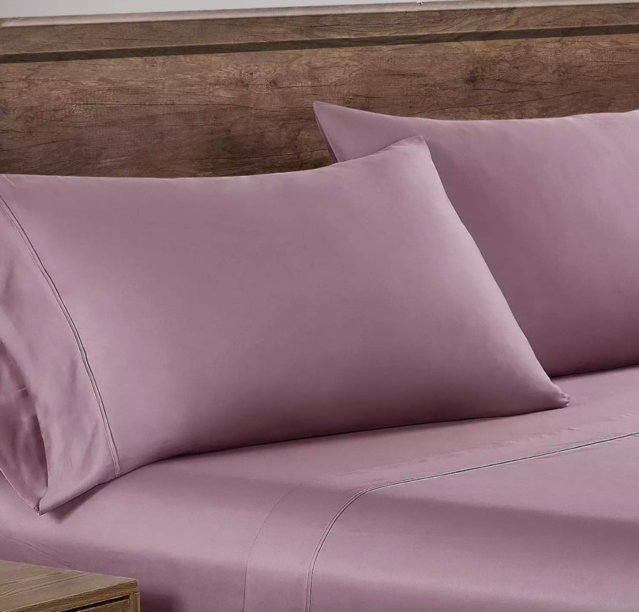 purple sheets on bed