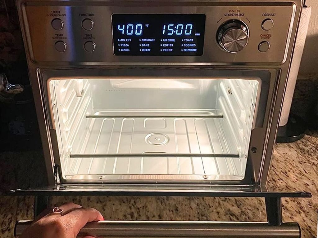 Comfee Air Fryer Oven with hand opening the door