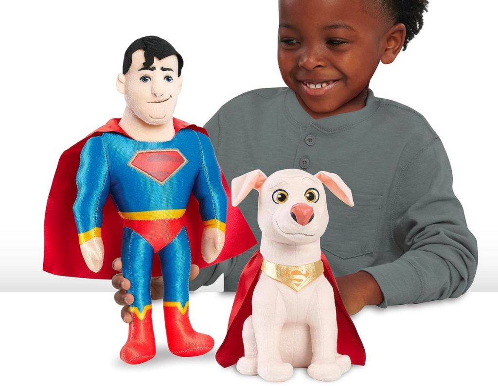 a little boy playing with DC Super Pets Superman KRYPTO 2Pack Plush