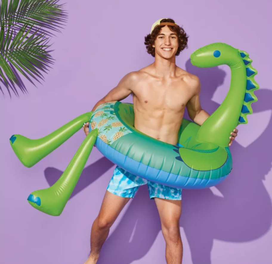man using a dinosaur pool float from Target, one of the best Target pool floats of 2024