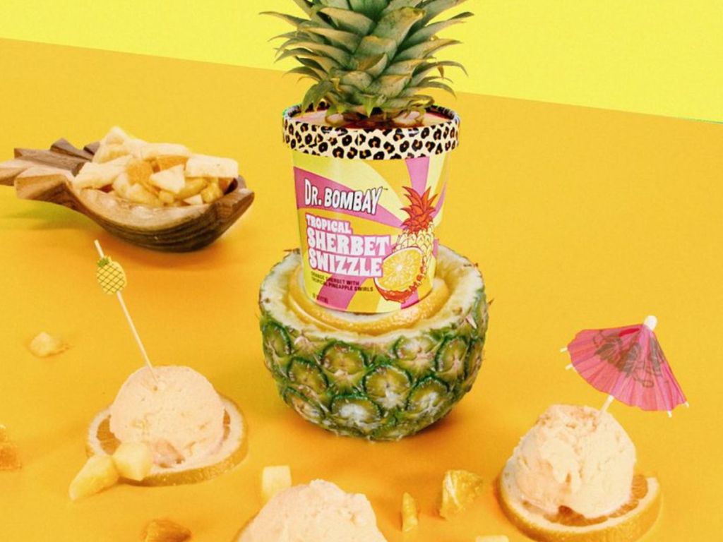 Dr. Bombay Sherbert Swizzle Ice Cream in a pineapple surrounded by cups of sherbet 