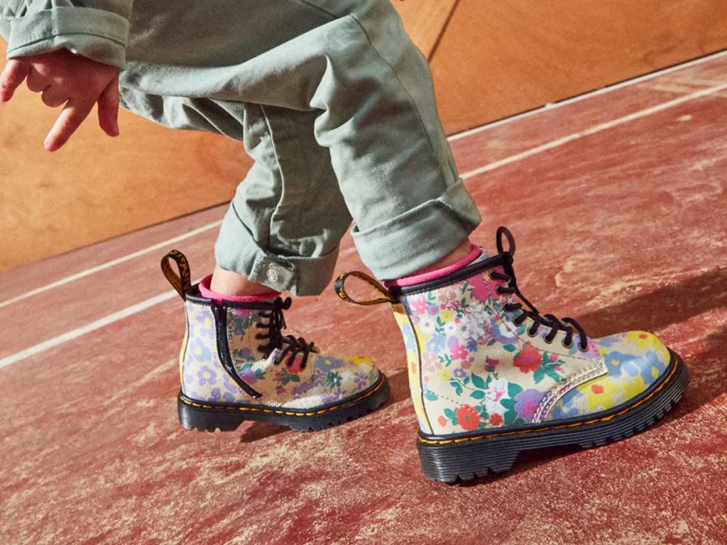 toddler wearing floral print dr martens boots