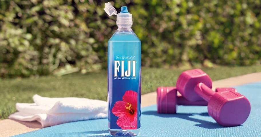 FIJI Natural Artesian Water 23.7oz bottle with fitness equipment