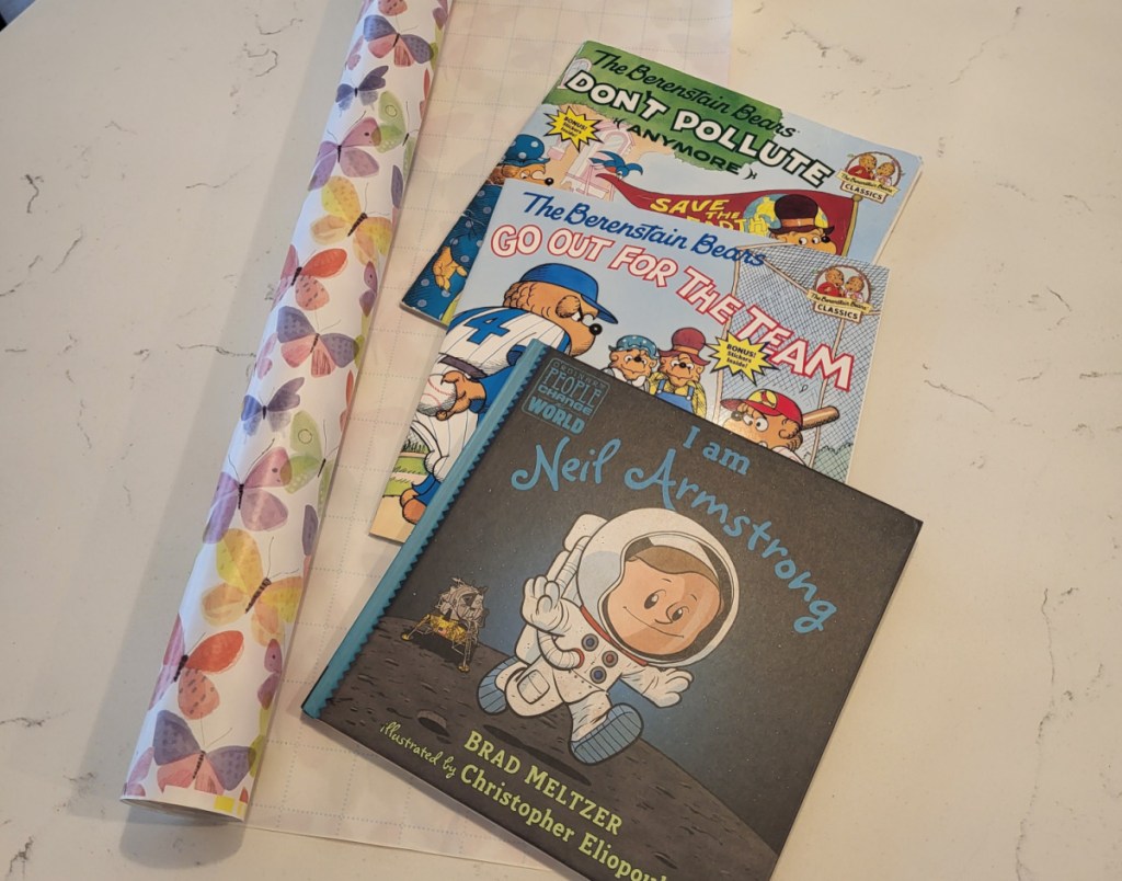 Free Books from the Kelloggs Feeding Reading program next to Dollar Tree Wrapping Paper