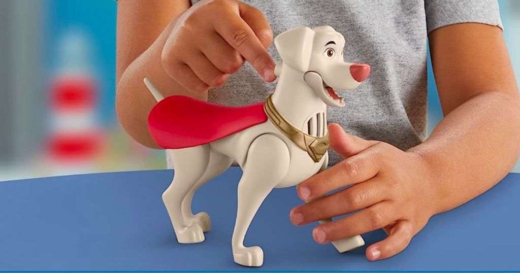 a little kid playing with a Fisher-Price DC League of Super-Pets Talking Krypto Poseable Figure