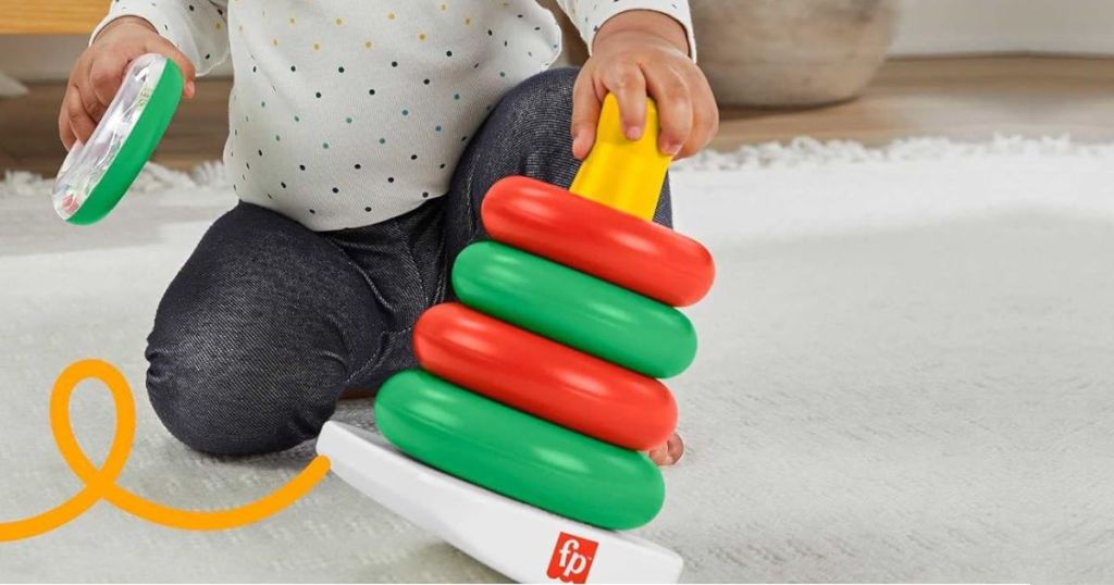 Child playing with a Fisher Price Holiday Rock a Stack Toy