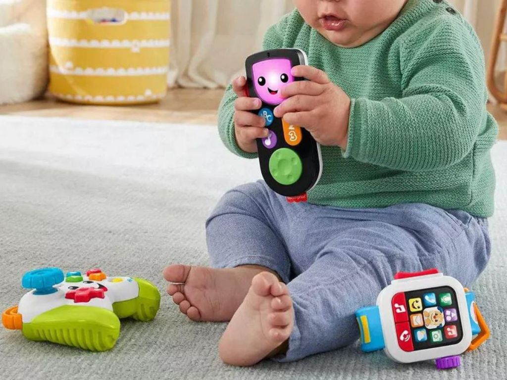 A baby playing with Fisher Price learning toys 