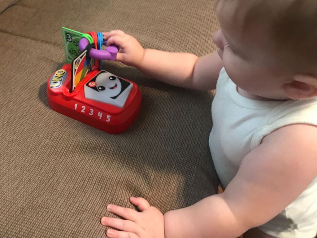 Baby playing with Fisher Price UNO toy