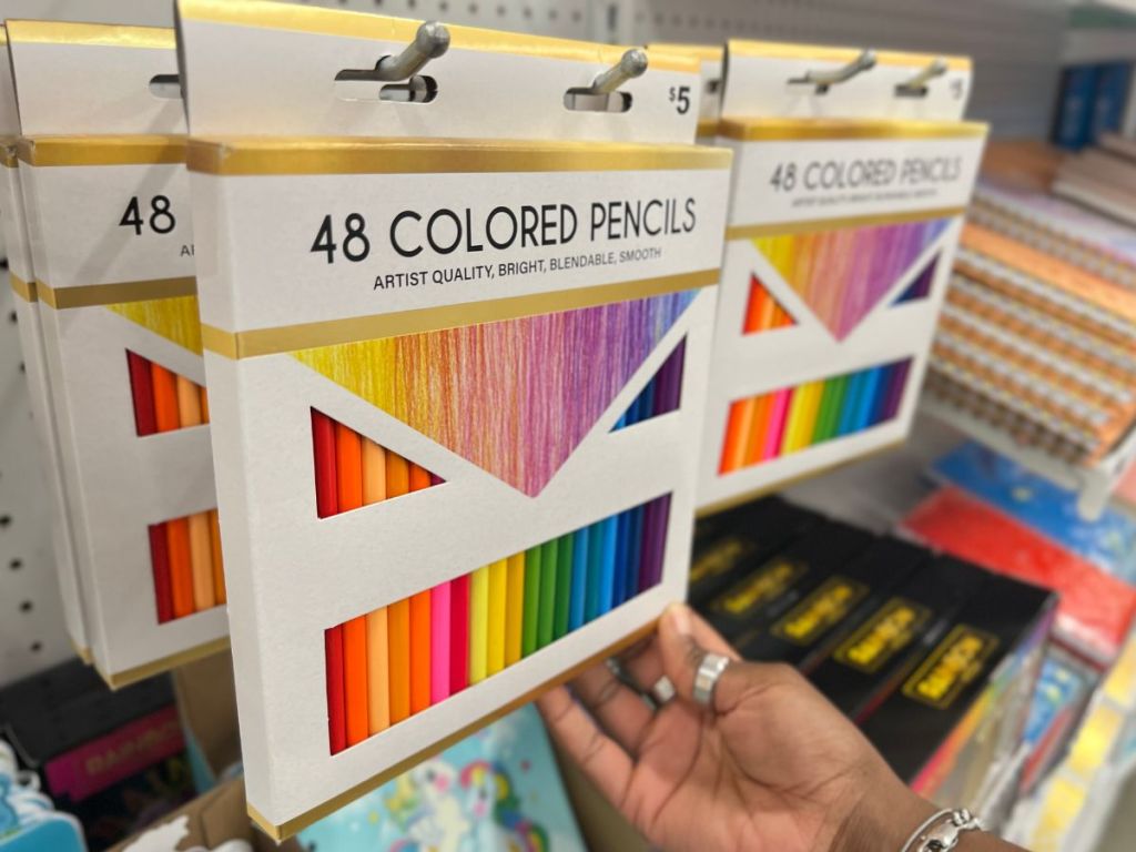 hand holding 48-count colored pencils hanging