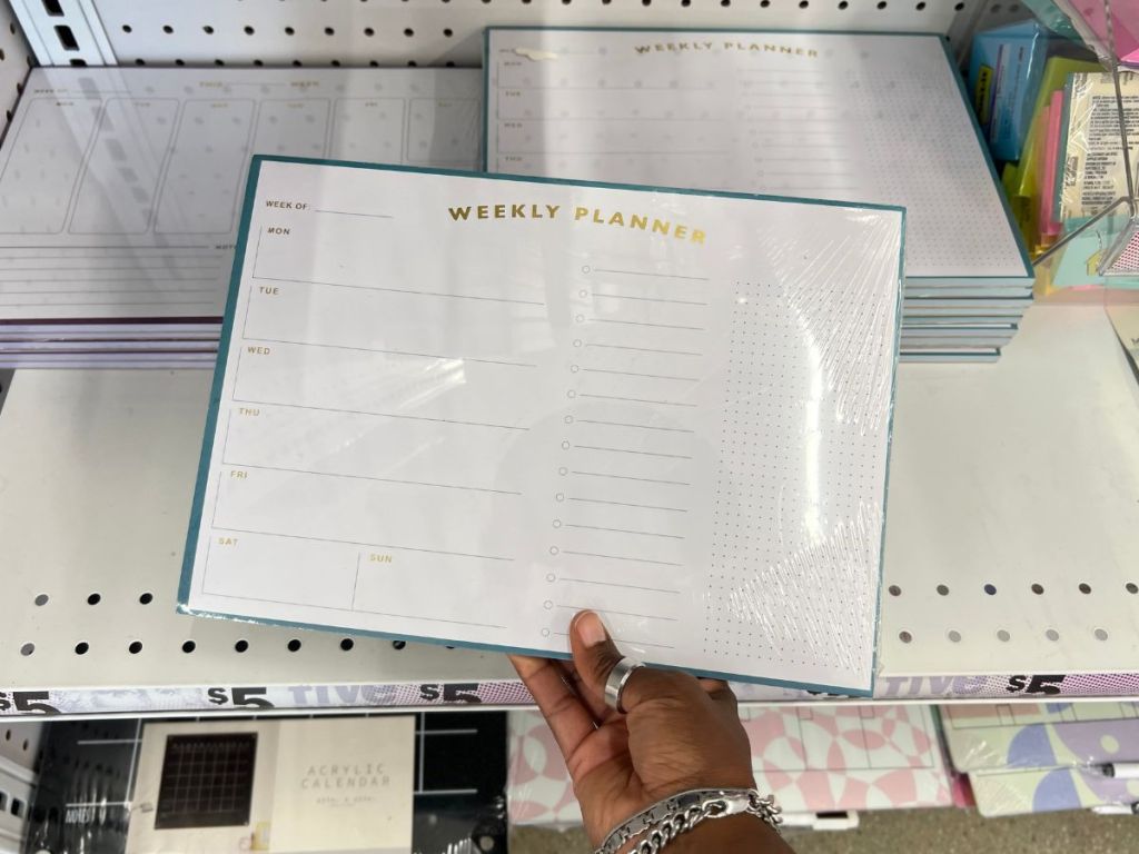 hand holding weekly desk planner