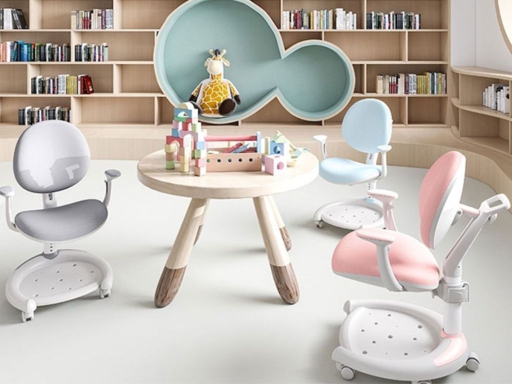 three kids desk chairs around a play table