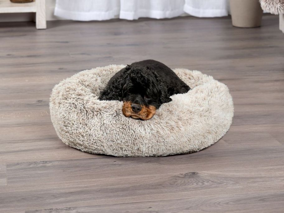 dog laying in FurHaven Calming Cuddler Long Fur Small Donut Dog Bed