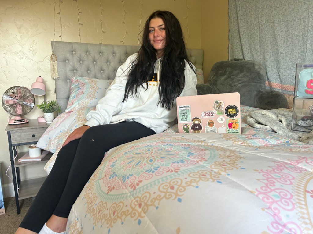 College girl surrounded by her dorm essentials she bought from walmart
