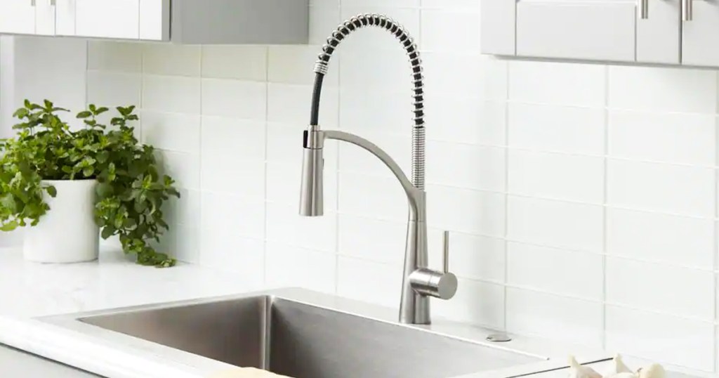 silver faucet with pull down sprayer at kitchen sink