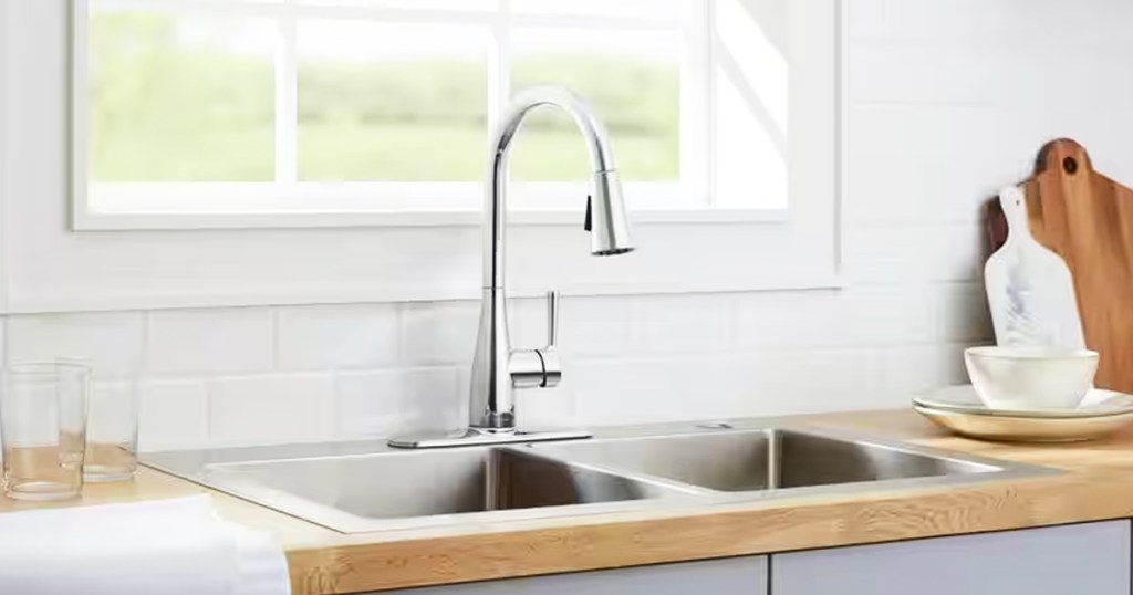 silver faucet at kitchen sink