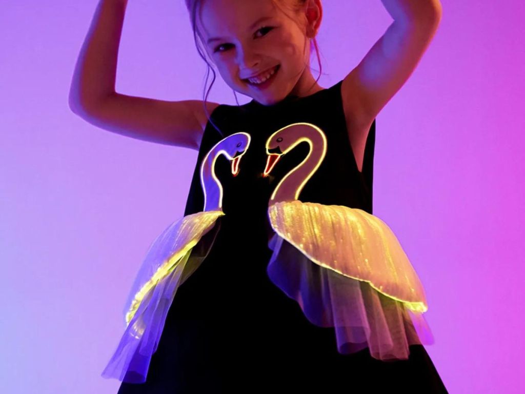 a child with glow in the dark swans