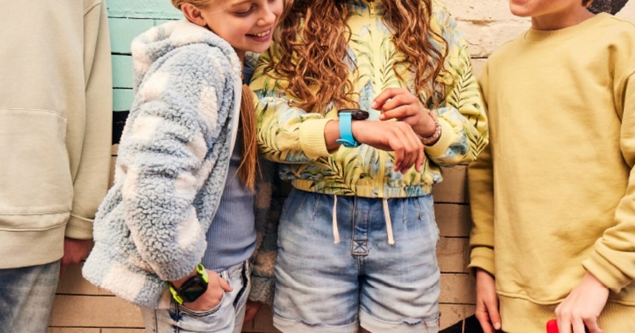 kids looking at smart watch on wrist 