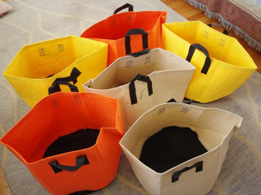 yellow, beige and orange canvas look plant grow bags sitting on the floor