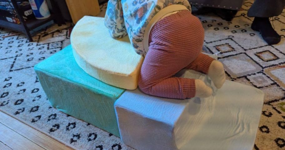 A toddler climbing on a soft climbing set