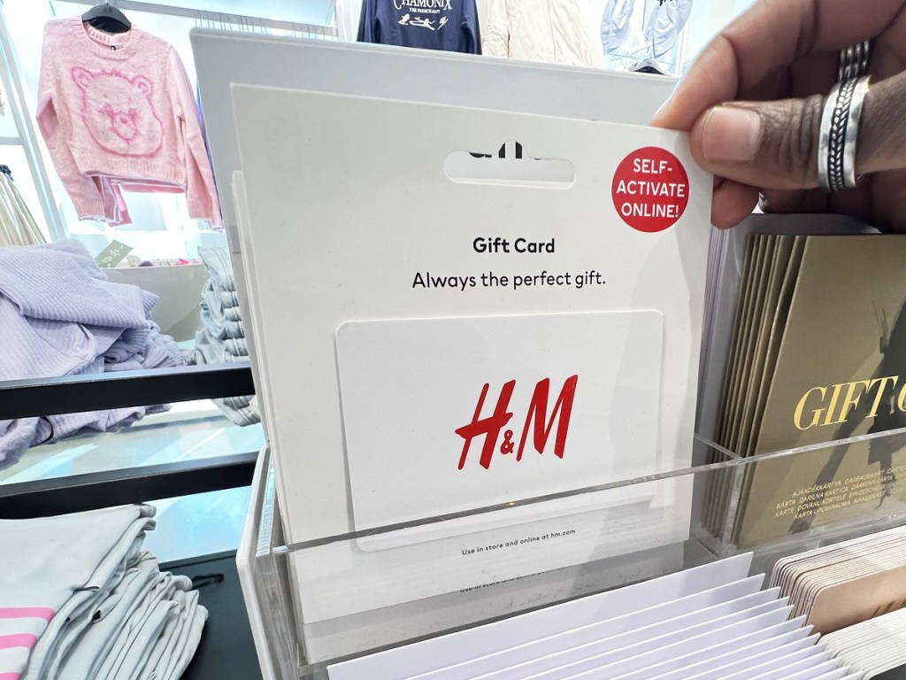 hand touching an H&M gift card