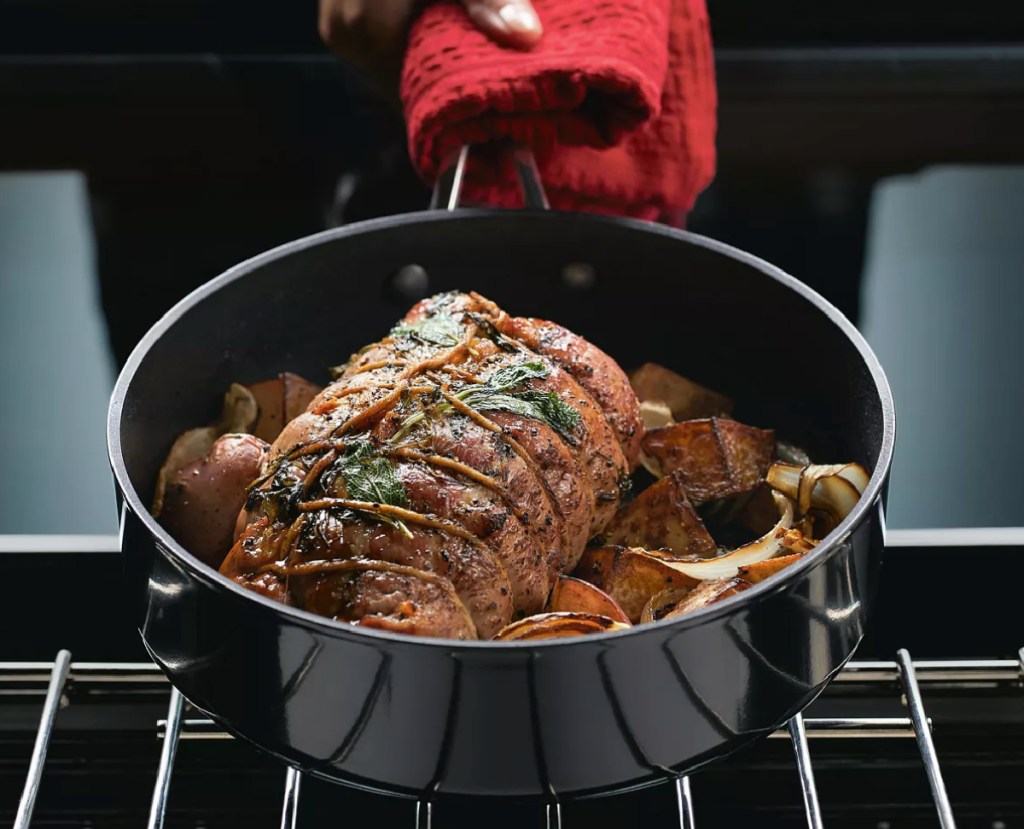 Hard Anodized Nonstick 3 Quart Sauté Pan with Lid with roast in it and hand holding it up