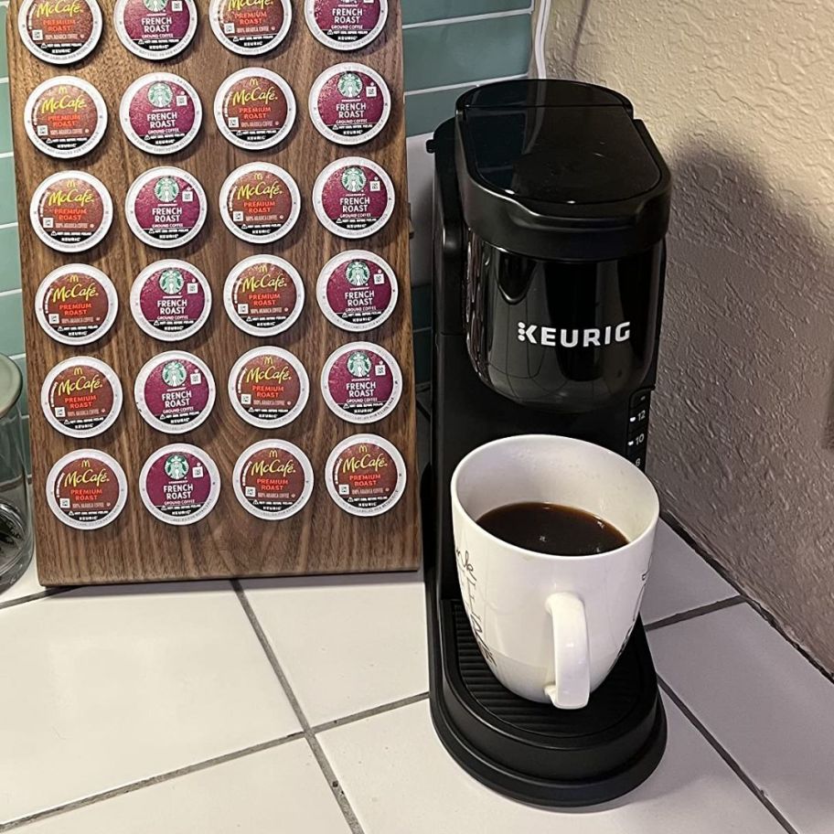 Keurig K-Express Single Serve K-Cup Coffee Maker shown on counter with coffee mug and k-cups beside of it