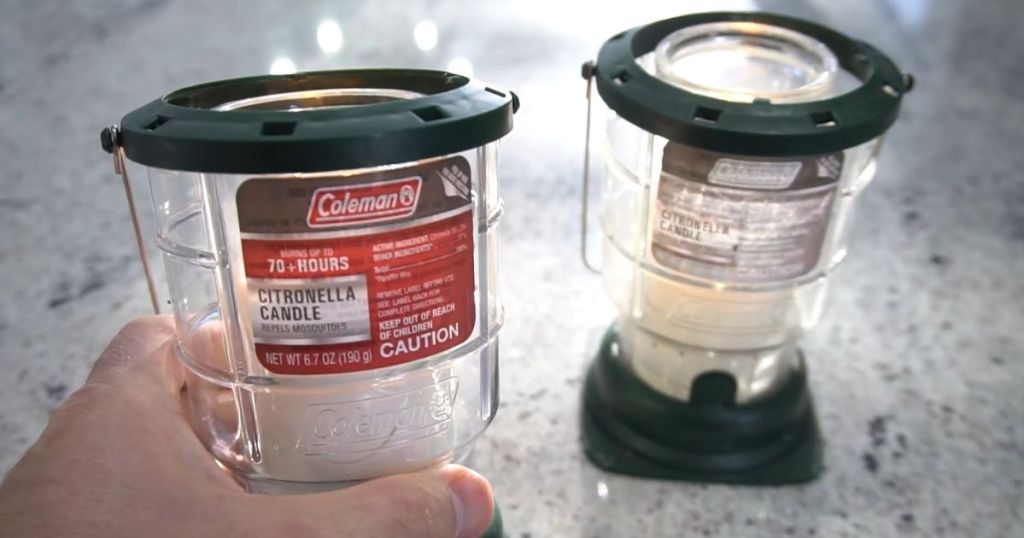Coleman Citronella Candle Lanterns shown on counter with man's hand