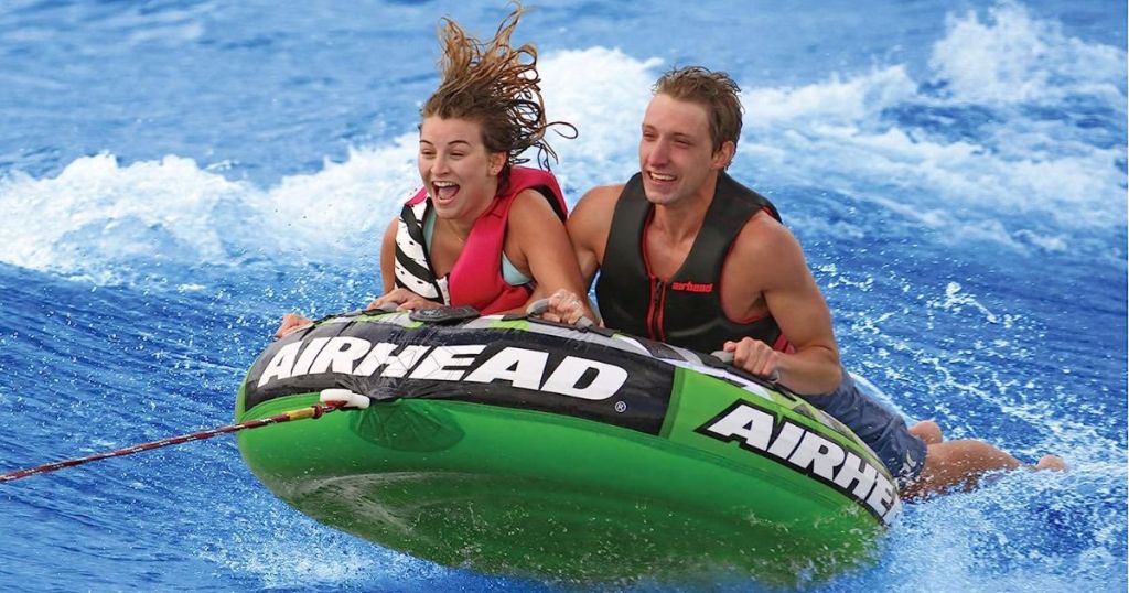Woman and man on an AIRHEAD Slice, Towable Tube for Boating in the water
