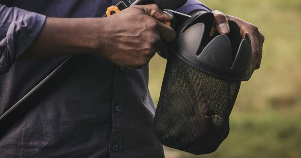 Fiskars Fruit Picker Basket shown with fruit in it with a man holding it 