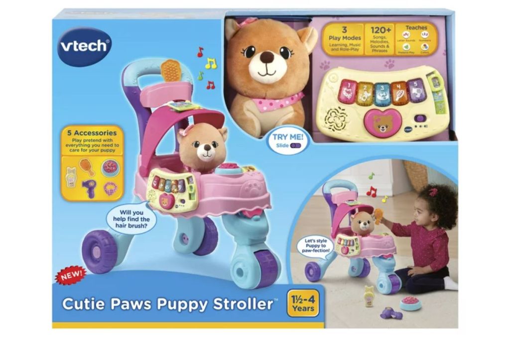 Little girl playing with a VTech Cutie Paws Puppy Stroller With Plush Puppy and Accessories