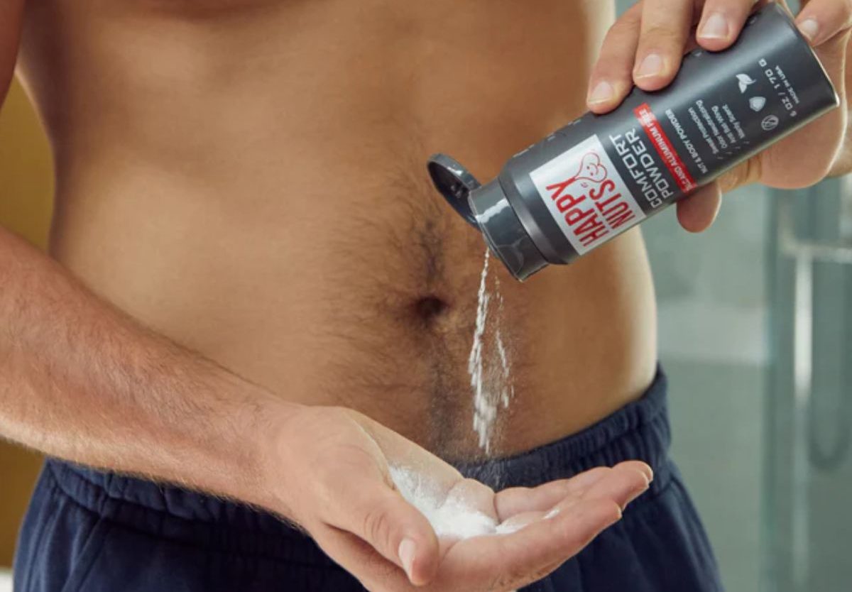 Happy Nuts Comfort Powder being used by a man, pouring into hand