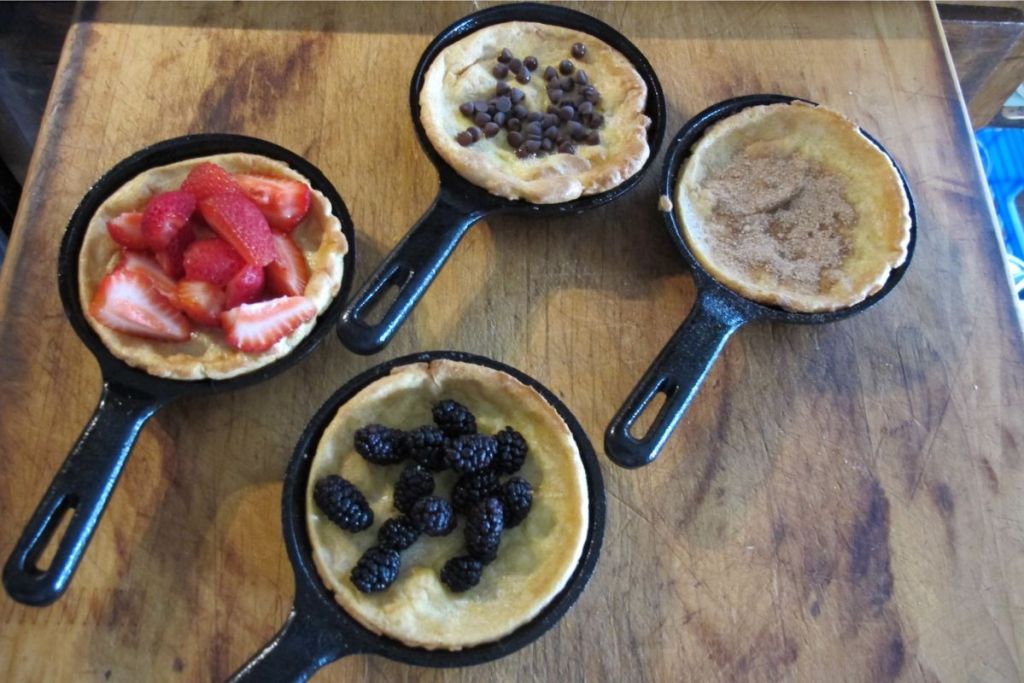 AmazonCommercial Pre Seasoned 3.5-Inch Cast Iron Skillet, Set of 4 shown with mini cobblers baked in them