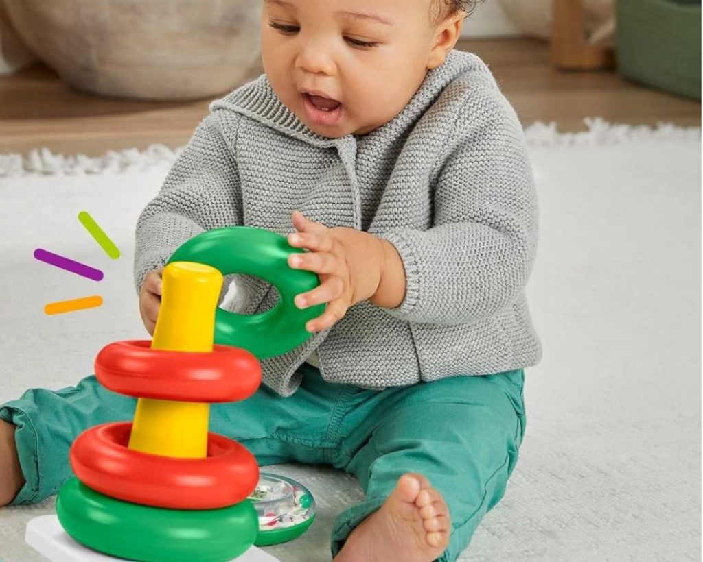 Baby playing with a Fisher Price holiday Rock-a-Stack Toy