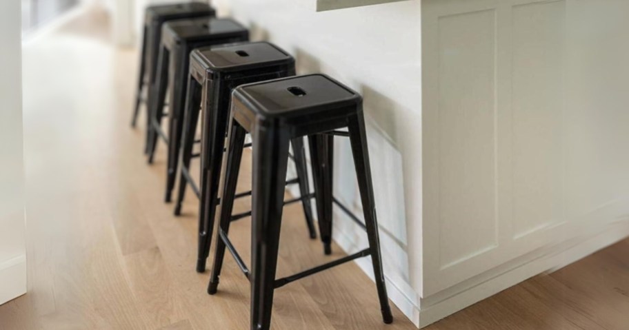 backless industrial bar stools in black sitting under counter