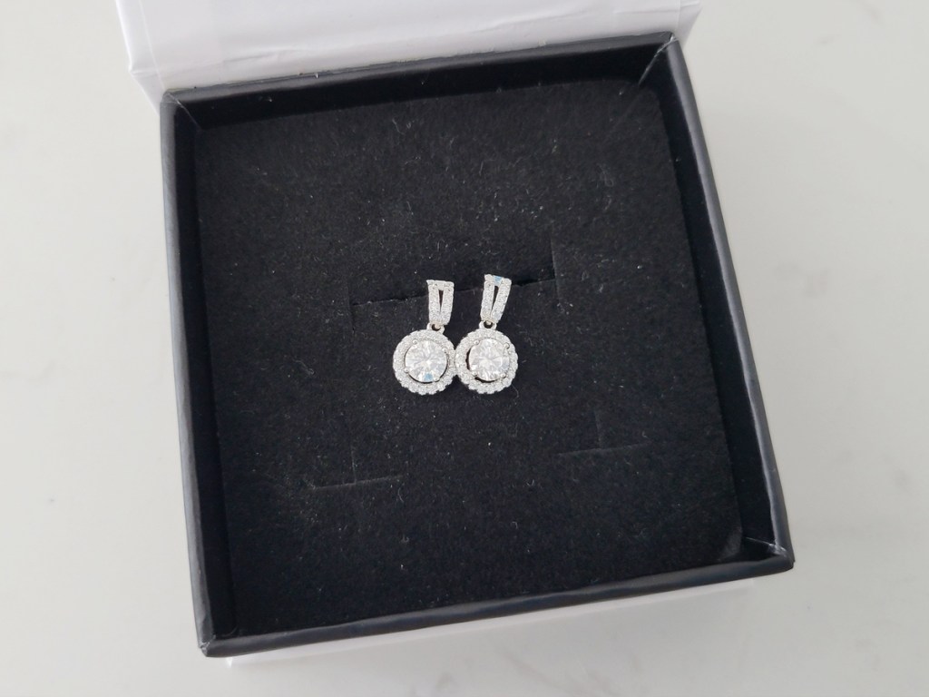pair of moissanite earrings in box