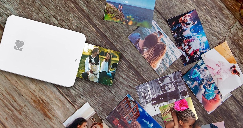 small white photo printer printing out photos on wood table