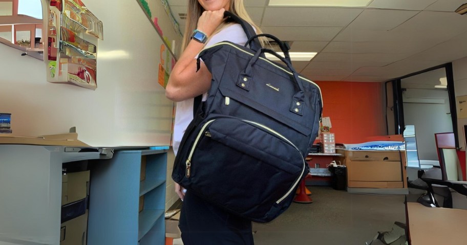 woman wearing black lovevook laptop backpack in classroom