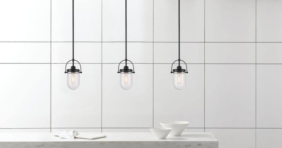 a group of three Lowell 1-Light Black Pendant hanging over a kitchen island