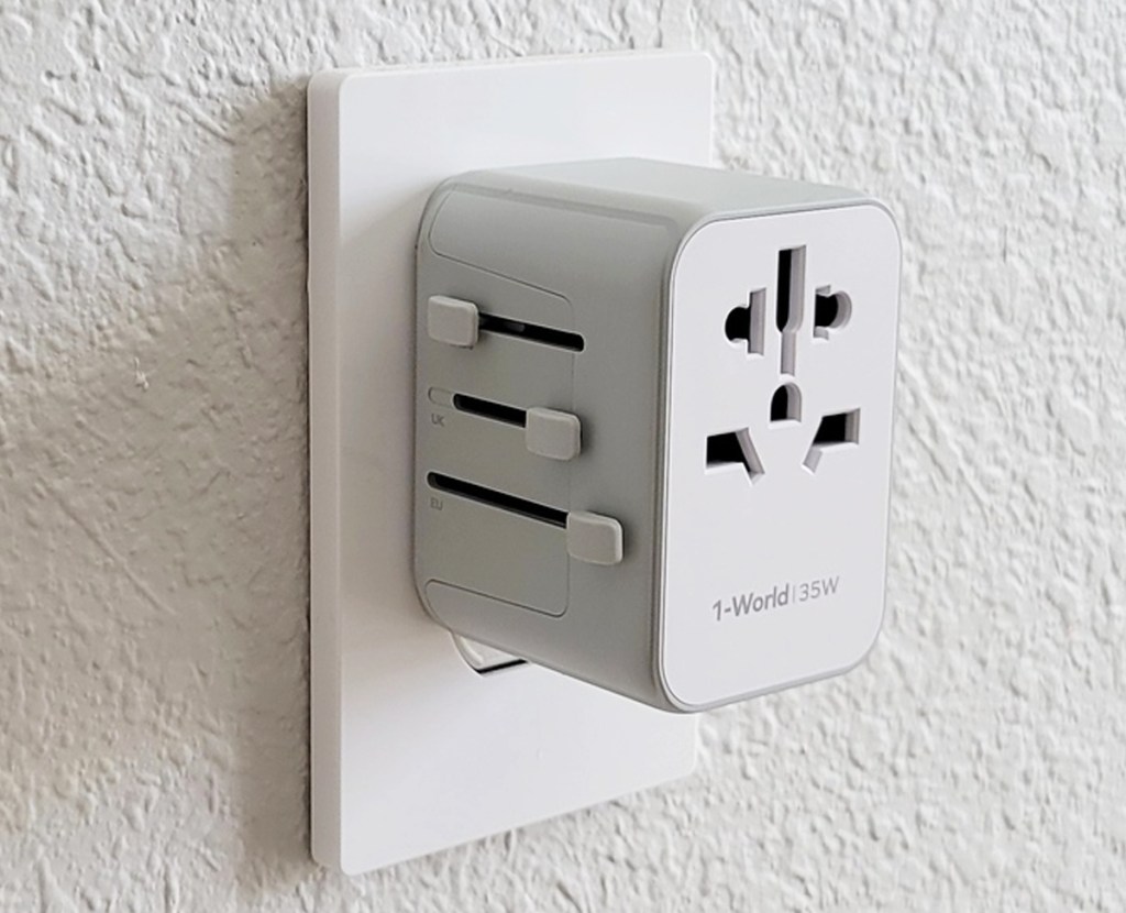 white travel adapter plug in wall socket