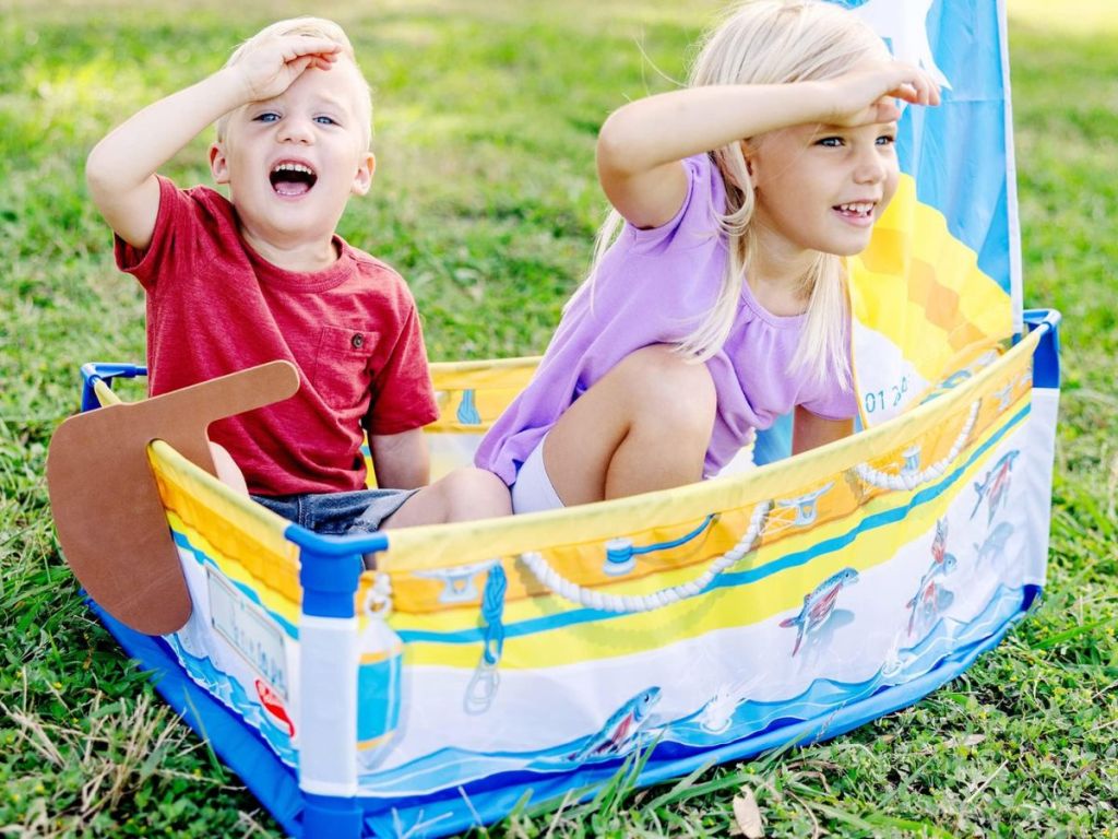 2 kids playing in a boat