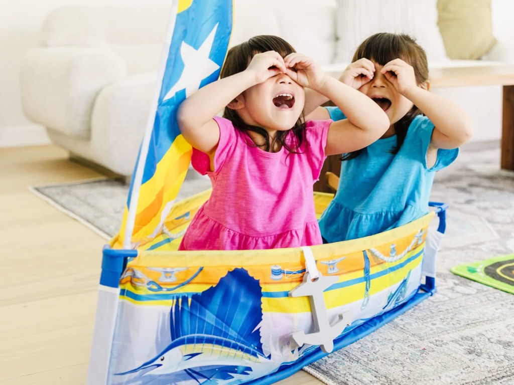 girl and boy playing in Melissa & Doug Let's Explore Sailboat