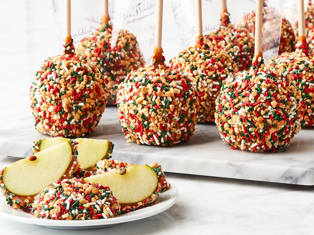 caramel apples covered in holiday sprinkles