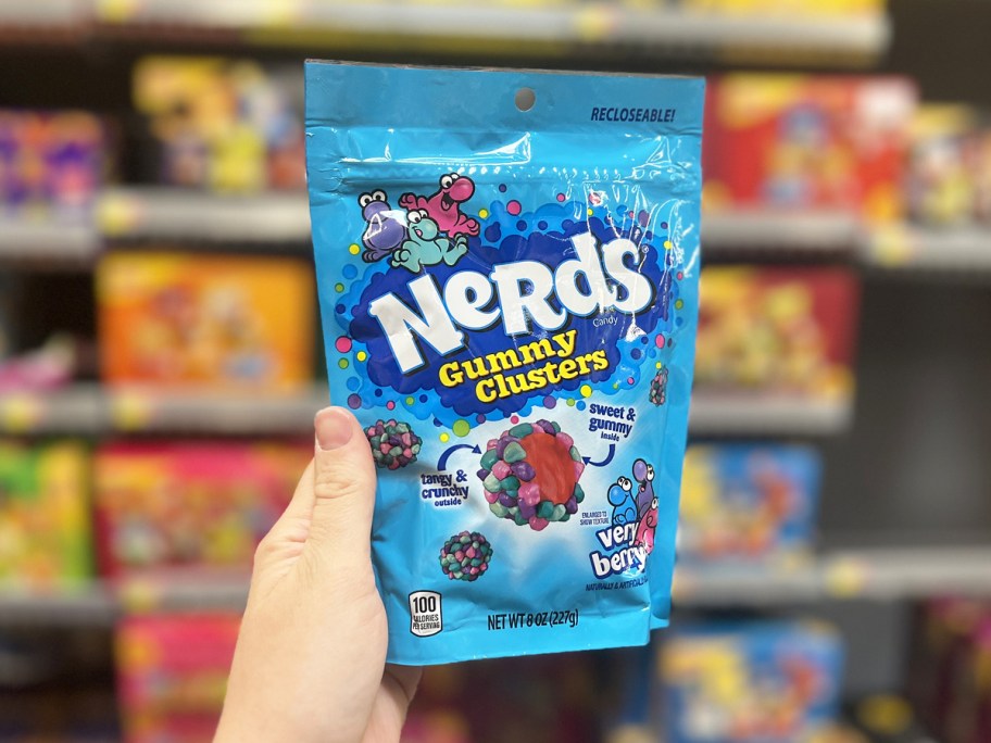 hand holding up a blue bag of Nerds Gummy Clusters