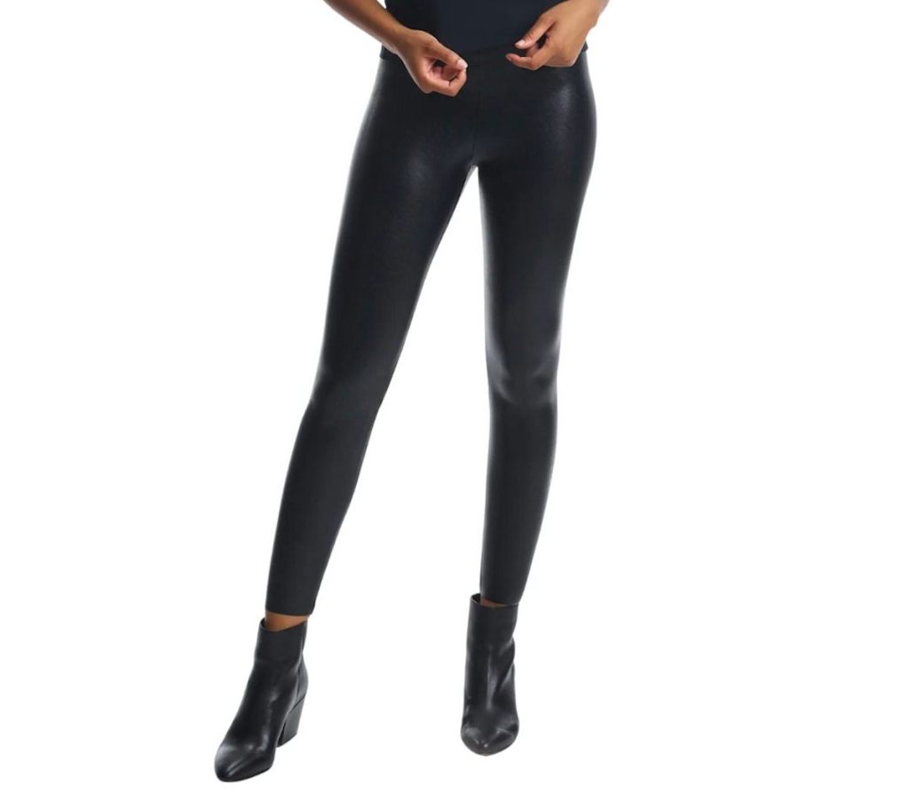 stock photo of white background with woman wearing black faux fur leggings
